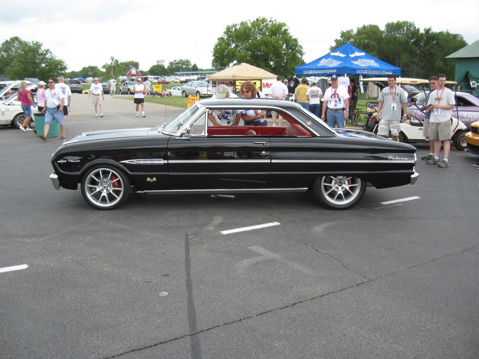 Black 1964 Ford Falcon coupe with red interior and aftermarket wheels