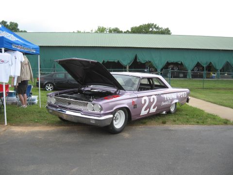 1968 Shelby GT500 - A purple 1963 Ford Galaxie, likely a race car, is displayed with its hood open at an outdoor event.