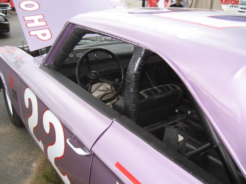 1968 Shelby GT500 - Interior view of a purple race car with a roll cage and racing seat, number 22 visible on the exterior.