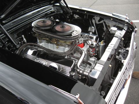 1968 Shelby GT500 - The engine bay of a classic car features a powerful V8 engine with dual carburetors and polished chrome components.