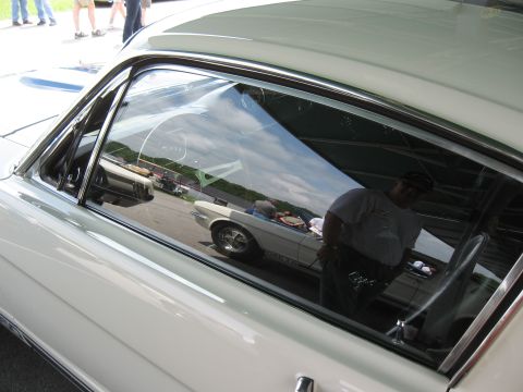 1968 Shelby GT500 - Reflection shows a white 1967 Mustang convertible with GT emblems visible on the rear quarter panel.