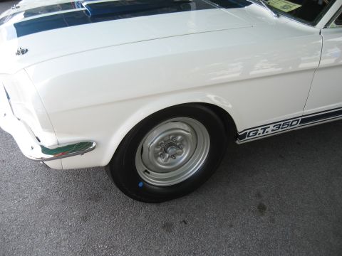 1968 Shelby GT500 - Close-up of a white 1965 Shelby GT350 with blue racing stripes and GT350 side decal.