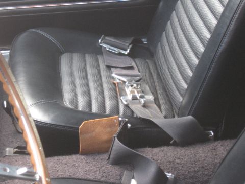 1968 Shelby GT500 - Close-up of a car's interior, focusing on the seat and seatbelt assembly.