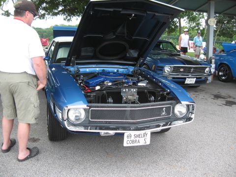 1968 Shelby GT500 - A blue 1969 Shelby Cobra S is displayed with its hood open, revealing the engine bay.