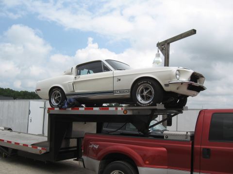 1968 Shelby GT500 - A white 1968 Shelby GT500KR is transported on a car hauler.