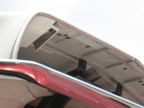 1968 Shelby GT500 - Close-up view of the underside of a car's rear bumper and trunk lid, showing mounting hardware.