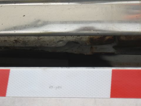 1968 Shelby GT500 - Detail of a vehicle's undercarriage showing rust and a reflective safety strip.