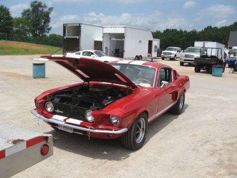 1968 Shelby GT500 - A classic red 1968 Shelby GT500 is displayed with its hood up at an outdoor event.