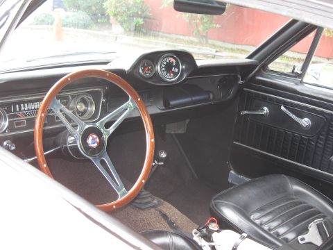 1968 Shelby GT500 - Interior view of a 1965 Ford Mustang, a wood steering wheel and custom gauges.