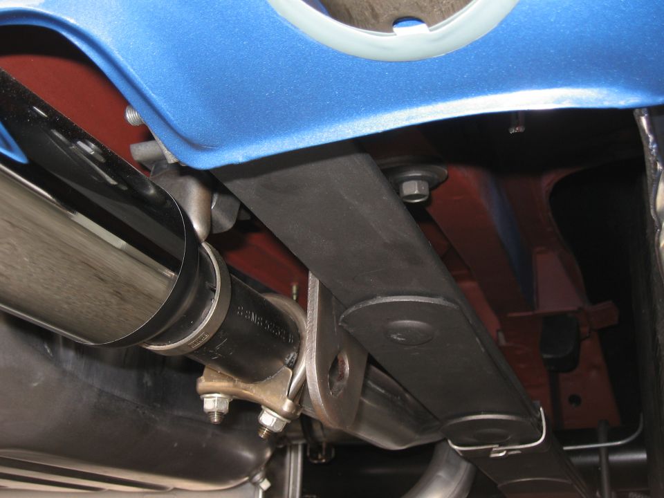 Close-up of exhaust pipe and leaf spring assembly