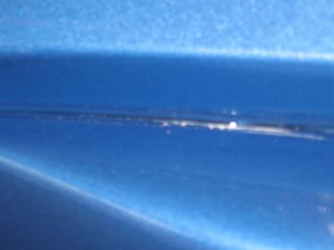 1968 Shelby GT500 - Detail shot of a blue car's exterior panel, showing a seam and minor surface imperfections.