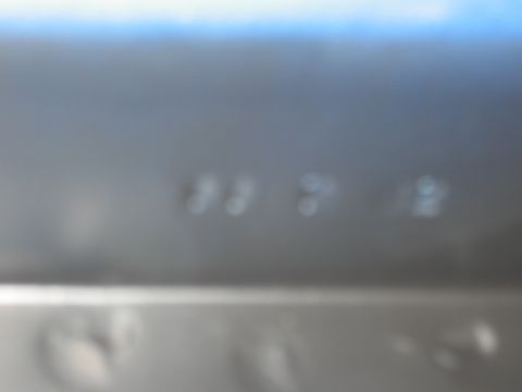 1968 Shelby GT500 - A close-up of a metallic surface shows blurry numbers, with a website logo visible.