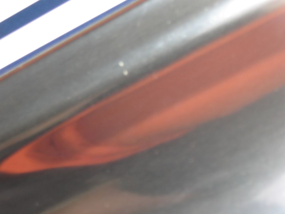 Red taillight and chrome trim with Supermotors logo