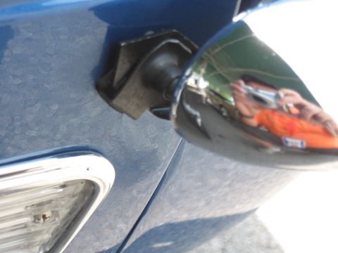 1968 Shelby GT500 - The mounting bracket for a side mirror is visible on a blue vehicle. A reflection shows the photographer.