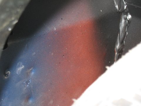 1968 Shelby GT500 - Detail of a vehicle's undercarriage, showing paint and weld marks.