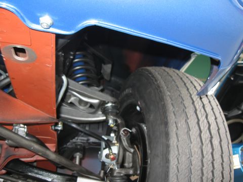 1968 Shelby GT500 - Detail shot of a vehicle's undercarriage, focusing on the suspension system and wheel assembly.