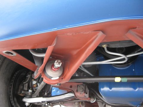 1968 Shelby GT500 - Close-up of suspension components and brake lines visible on the underside of a blue car.