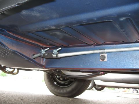 1968 Shelby GT500 - Close-up of car's underbody, focusing on brake lines and a rear wheel. 'GAT' is visible on a clamp.