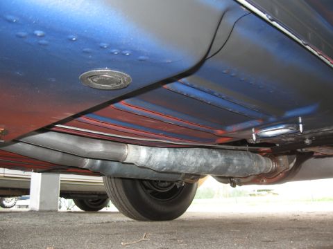 1968 Shelby GT500 - The undercarriage of a vehicle, its exhaust system and a portion of the rear wheel.