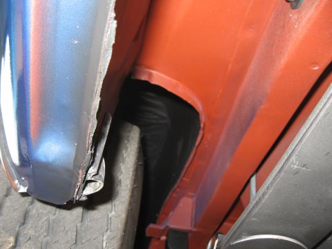 1968 Shelby GT500 - Close-up view of a car's wheel well and fender edge, revealing the painted interior frame.