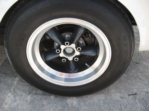 1968 Shelby GT500 - Close-up of a five-spoke wheel and tire assembly on a vehicle.