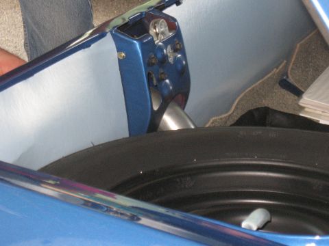 1968 Shelby GT500 - Close-up of a car's trunk showing the latch mechanism and spare tire.