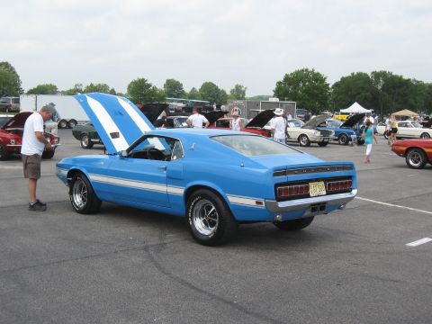 1968 Shelby GT500 - A blue 1969 Shelby GT500 is parked at an outdoor car show with its hood open.