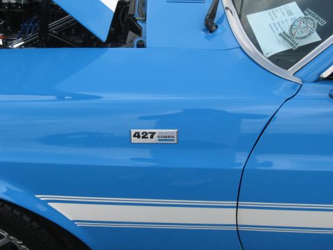 1968 Shelby GT500 - Close-up of a 1968 Shelby GT500 fender, showing the 427 Cobra badge and racing stripe.
