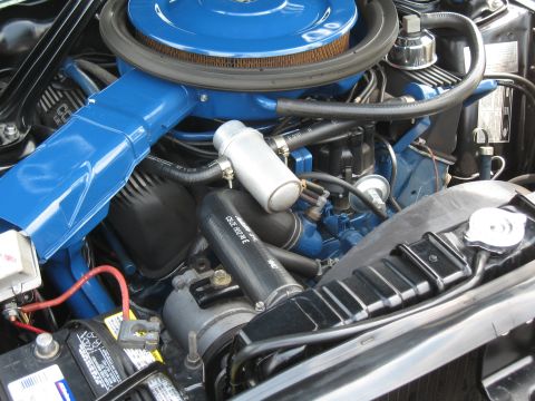 1968 Shelby GT500 - Close-up view of a vehicle's engine bay, highlighting the blue air cleaner and intake components.