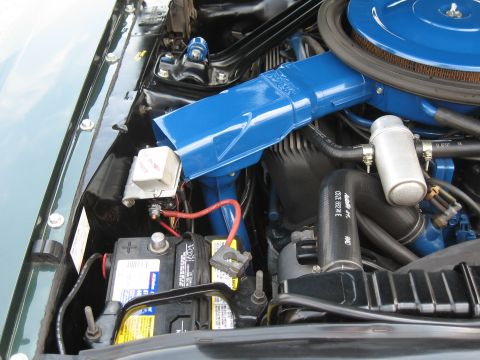 1968 Shelby GT500 - Close-up of a car's engine bay, showing the air cleaner and battery components.