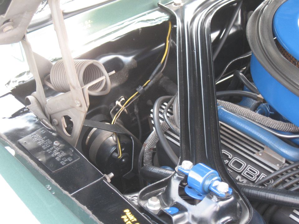 Green 1968 Shelby GT500 engine bay with blue Cobra air cleaner and visible VIN plate
