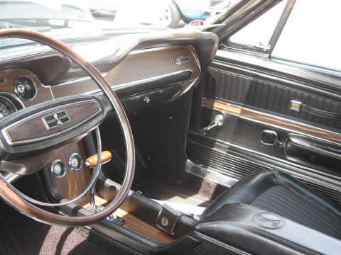 1968 Shelby GT500 - Interior view of a 1968 Shelby GT500, highlighting the woodgrain trim and iconic steering wheel emblem.