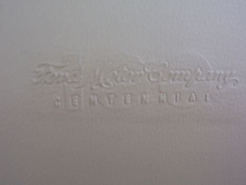 2003 Ford Taurus - Embossed text indicates "Ford Motor Company CENTENNIAL" on a light surface.