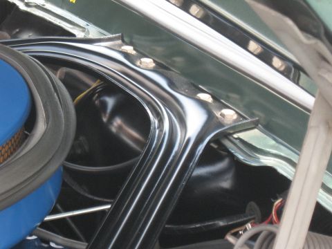 1968 Shelby GT500 - Engine bay strut tower brace with visible bolts and part of an air filter housing.