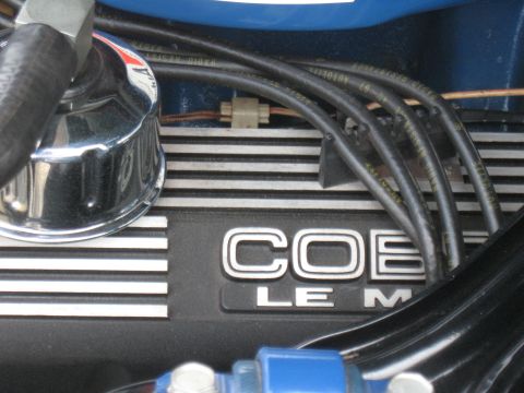 1968 Shelby GT500 - Detail of a Cobra engine valve cover with 'COBRA' and 'LE M' visible, along with spark plug wires.