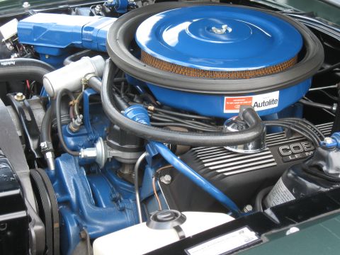 1968 Shelby GT500 - Close-up of a vehicle's engine bay, a prominent blue air cleaner assembly and "COBRA LE M" branded valve covers.