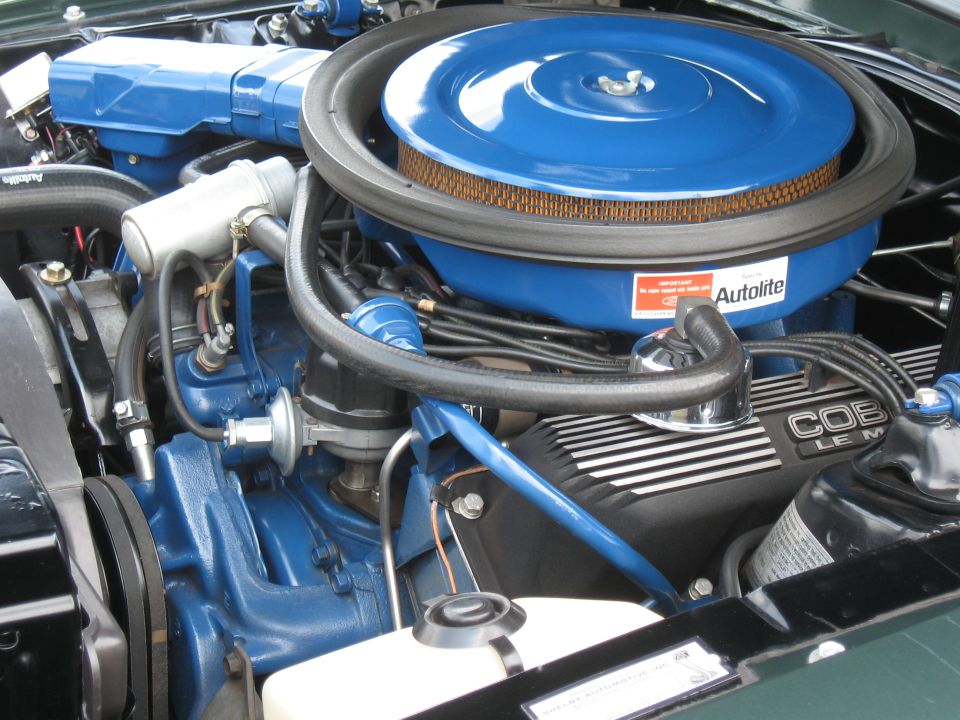 Engine bay with blue air cleaner and "COBRA LE M" valve covers