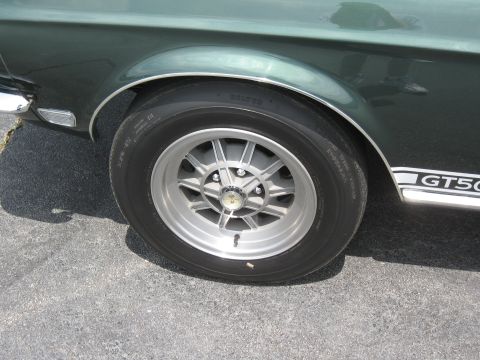 1968 Shelby GT500 - Close-up of the front wheel and fender emblem on a 1968 Shelby GT500.