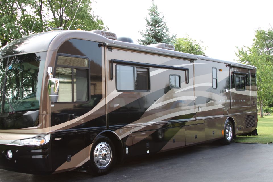Brown motorhome with beige and black wavy stripes, side view