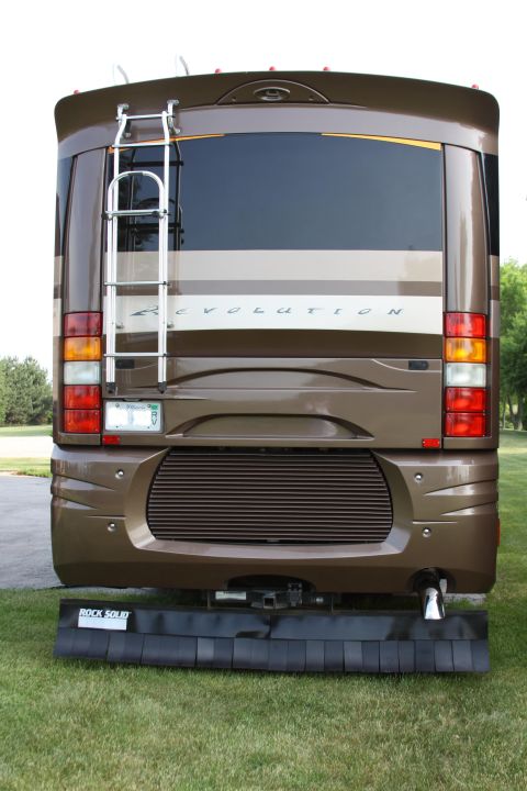 2003 Ford F-350 - The rear of a large RV shows a ladder, taillights, and a license plate.