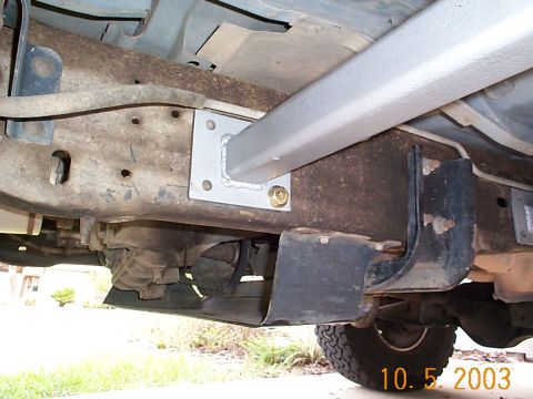 1992 Ford Bronco - Passenger side slider mounted and held in place with one bolt. Undo the clips that hold the fuel return line and move them up and out of th…