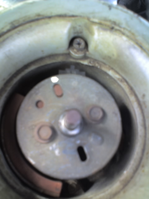 1992 Ford Bronco - Close-up view of the interior of a distributor cap, showing the rotor and mounting screws.