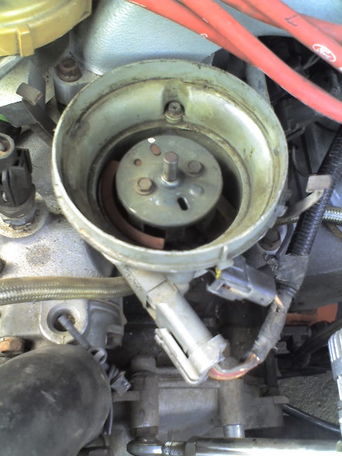 1992 Ford Bronco - Distributor cap and rotor assembly from a Ford vehicle, showing internal components.