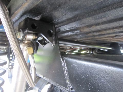 1974 Ford Bronco - Custom suspension modifications are visible on the underside of the vehicle, including a sway bar and shock absorber mount.