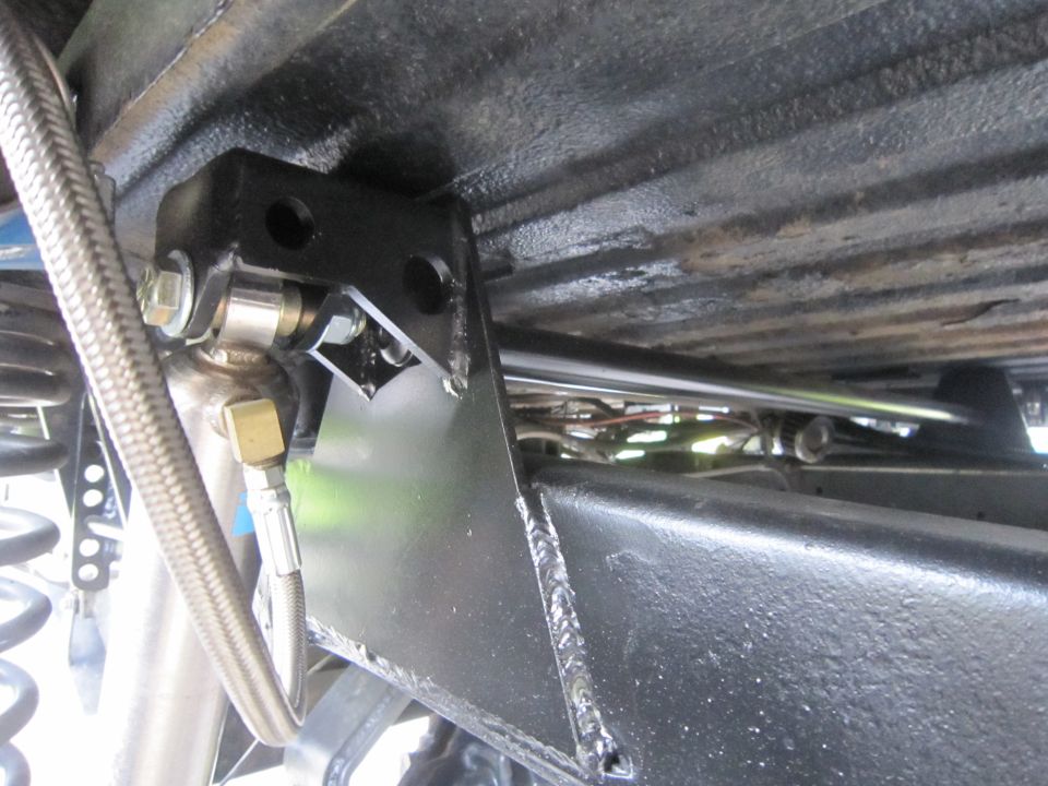 close-up of aftermarket shock mount and sway bar on vehicle frame