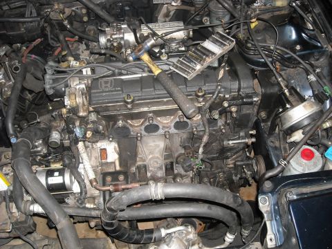 1979 Ford F-150 - The engine bay of a Honda vehicle, with a hammer and socket set resting on the engine cover.