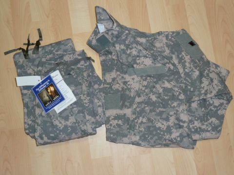 1992 Ford Mustang - A military camouflage uniform, including pants and a jacket, is laid out on a wooden floor with informational tags attached.