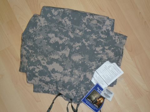 1992 Ford Mustang - A folded military camouflage uniform lies on a wooden floor, with several tags attached.