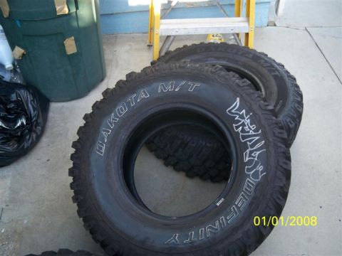 1992 Jeep Wrangler - Off-road tires are shown for sale, with visible branding and a date stamp.