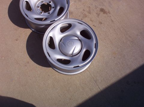 1988 Ford Bronco - Close-up of two silver wheels, each a Toyota logo on the center cap.